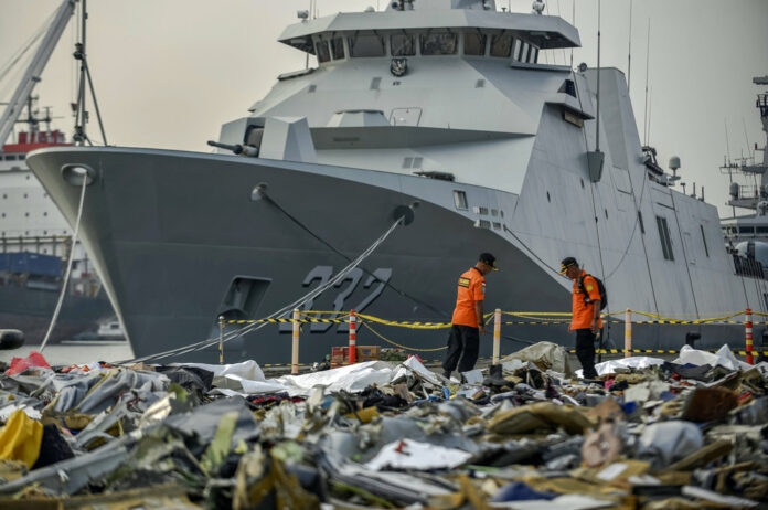 Members of National Search and Rescue Agency inspect debris Wednesday retrieved from the waters where Lion Air flight JT 610 is believed to have crashed, at Tanjung Priok Port in Jakarta, Indonesia. Photo: Fauzy Chaniago / Associated Press