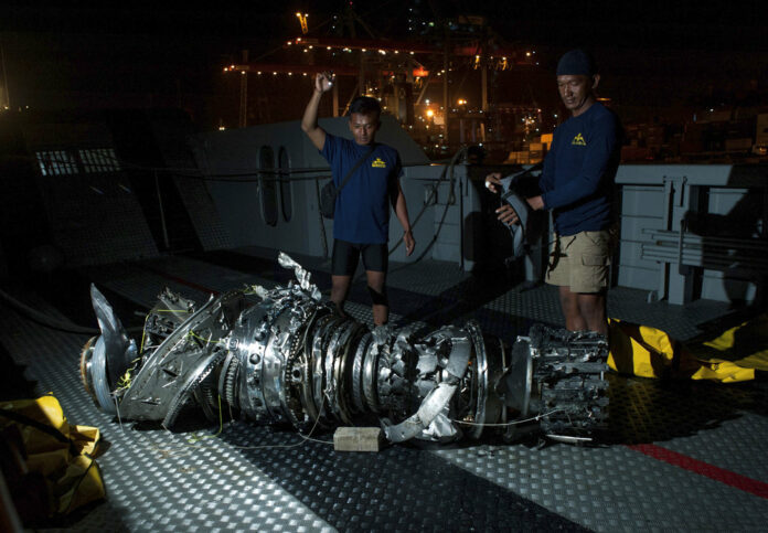 Navy divers inspect Saturday what is believed to be engine of the crashed Lion Air jet after it was retrieved from the sea floor, at Tanjung Priok Port in Jakarta, Indonesia. Photo: Fauzy Chaniago / Associated Press Navy divers inspect Saturday what is believed to be engine of the crashed Lion Air jet after it was retrieved from the sea floor, at Tanjung Priok Port in Jakarta, Indonesia. Photo: Fauzy Chaniago / Associated Press