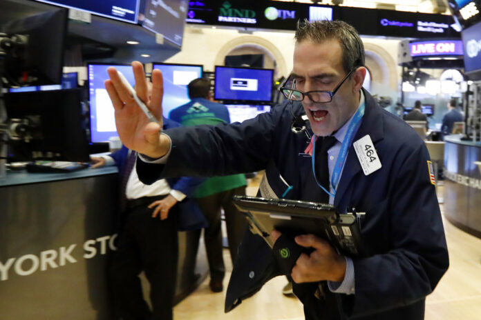 Trader Gregory Rowe works Nov. 7 on the floor of the New York Stock Exchange. Photo: Richard Drew / Associated Press