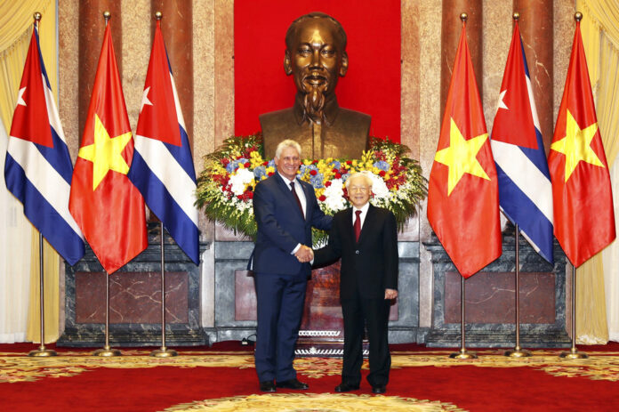 Vietnamese President Nguyen Phu Trong, right, shakes hands Friday with his Cuban counterpart Miguel Diaz-Canel in in Hanoi, Vietnam. Photo: Tri Dung / Associated Press