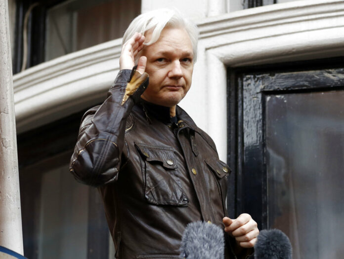 Julian Assange In this May 19, 2017, file photo, WikiLeaks founder Julian Assange greets supporters from a balcony of the Ecuadorian embassy in London. Photo: Frank Augstein / Associated Press