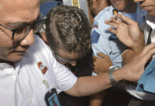 Australian Drug Smuggler Returns Home From Bali Jail Australian Renae Lawrence, center, is escorted Wednesday as she leaves Bangli prison in Bali, Indonesia. Photo: Dana Pradana / Associated Press