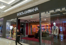 Dolce&Gabbana Show Canceled in China Over Racial Slurs A woman walks out of an outlet of Dolce&Gabbana in Shanghai, China Wednesday Nov. 21, 2018. Photo: Chinatopix Via AP