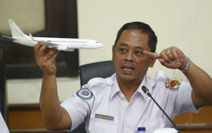 National Transportation Safety Committee investigator Nurcahyo Utomo holds a model of an airplane during a Wednesday press conference on the committee's preliminary findings on their investigation on the crash of Lion Air flight 610, in Jakarta, Indonesia. Photo: Achmad Ibrahim / Associated Press