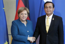 Merkel Encourages Prayuth to Lead Country to Democracy German Chancellor Angela Merkel, left, and Thailand's Prime Minister Prayut Chan-o-cha, right, shake hands Wednesday after a joint statement at the chancellery in Berlin, Germany. Photo: Michael Sohn / Associated Press