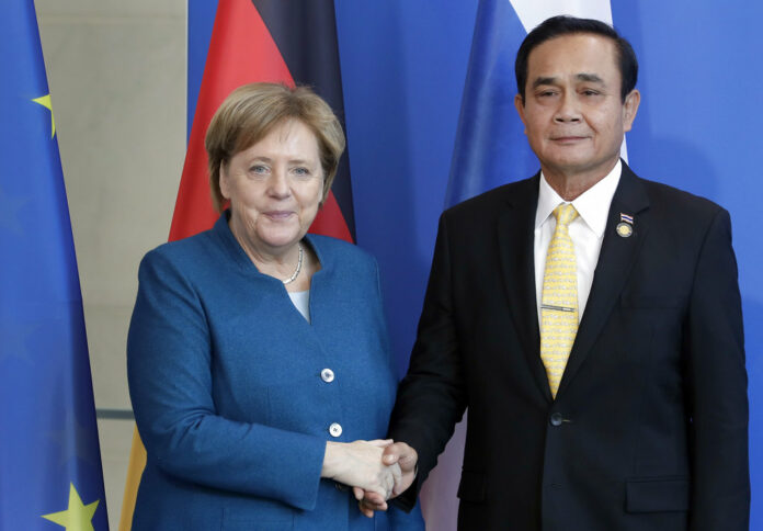 German Chancellor Angela Merkel, left, and Thailand's Prime Minister Prayut Chan-o-cha, right, shake hands Wednesday after a joint statement at the chancellery in Berlin, Germany. Photo: Michael Sohn / Associated Press German Chancellor Angela Merkel, left, and Thailand's Prime Minister Prayut Chan-o-cha, right, shake hands Wednesday after a joint statement at the chancellery in Berlin, Germany. Photo: Michael Sohn / Associated Press