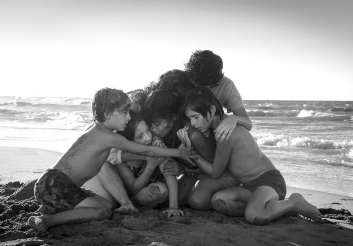 This image released by Netflix shows Yalitza Aparicio, center, in a scene from the film