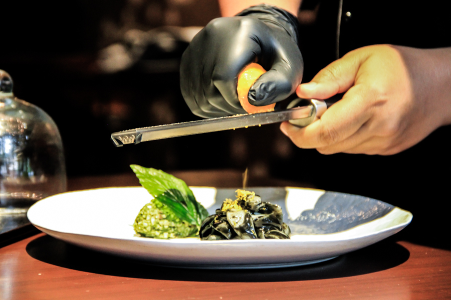 Chef Aom grates a dehydrated duck egg onto ‘Stir-Fried.’ 