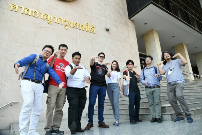 The eight activist leaders imitate a viral anti-junta rap song My Country's Got at the court today.