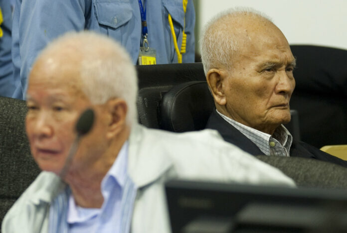 Khieu Samphan, at left, former Khmer Rouge head of state, and Nuon Chea, at right, who was the Khmer Rouge's chief ideologist and No. 2 leader, sit in the court hall at the U.N.-backed war crimes tribunal in Phnom Penh in an October 2013 file photo released by the Extraordinary Chambers in the Courts of Cambodia. Photo: Mark Peters / Extraordinary Chambers in the Courts of Cambodia via AP