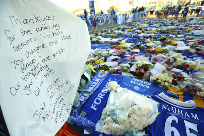 A personal salute is placed among tributes Friday at Leicester City football club Friday for Leicester Chairman Vichai Srivaddhanaprabha. Photo: Nigel French / PA