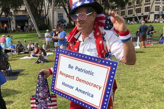 Harvey Rosenfeld attends a Democratic party rally Saturday in West Palm Beach, Florida, bedecked in a red, white and blue outfit topped with an Uncle Sam hat and had a sign around his neck reading, “Be Patriotic, Respect Democracy, Honor America.” The 68-year-old retired publicist said he had been a Republican for 30 years until its stances against abortion rights and gay rights drove him away. Photo: Terry Spencer / Associated Press