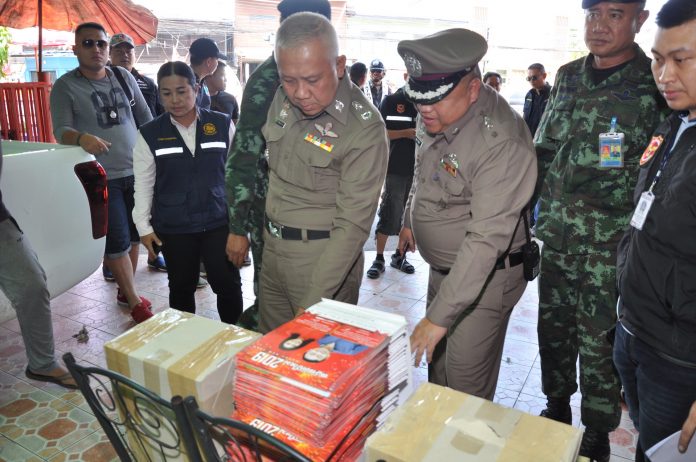 Soldiers and police seize calendars bearing pictures of former leaders Thaksin and Yingluck Shinawatras in Ubon Ratchathani.
