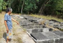 15 Stillborns Feared Stolen From Rayong Grave for Black Magic A local resident stands Saturday near broken tombs in Rayong province where 15 stillborn babies were reportedly missing.