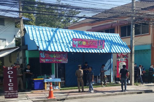 Police talk to people Wednesday outside a shop in Saraburi province where five teen boys are accused of sexually assaulting a 12-year-old girl.