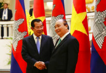 Cambodia’s Hun Sen Says No to Foreign Military Bases Cambodian Prime Minister Hun Sen, left, shakes hands Friday with his Vietnamese counterpart Nguyen Xuan Phuc before heading for talks behind closed doors in Hanoi, Vietnam. Photo: Tran Van Minh / Associated Press