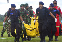 Rebels Demand Indonesia Negotiate on Papua Independence Indonesian soldiers and police officers carry a body bag Friday containing the body of a victim of separatist attack in Nduga district upon its arrival at Moses Kilangin Airport in Timika, Papua province, Indonesia. Photo: Mujiono / Associated Press
