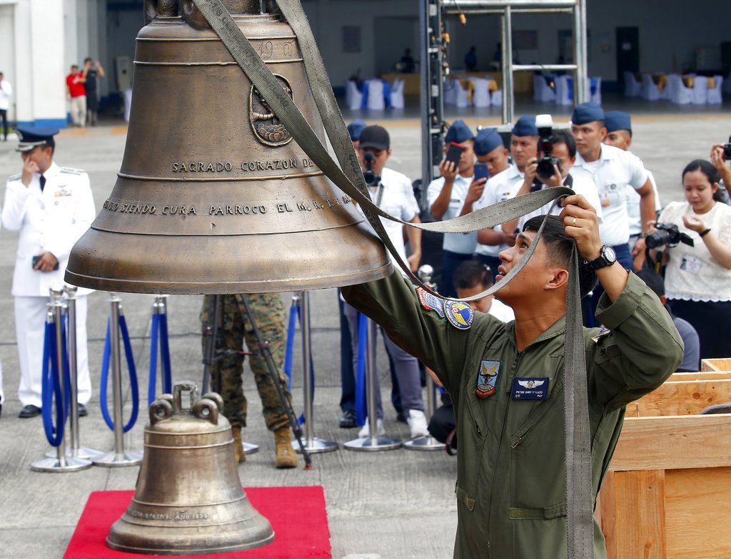 Philippine Air Force personnel unload three church bells Tuesday seized by American troops as war trophies more than a century ago, as they arrive in suburban Pasay city, southeast of Manila, Philippines. Photo: Bullit Marquez / Associated Press