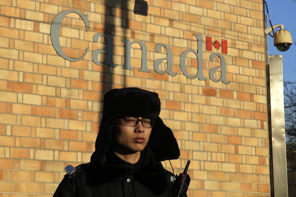 A policeman stands watch Wednesday outside the Canadian Embassy in Beijing. A Canadian court granted bail on Tuesday to a top Chinese executive arrested at the United States' request in a case that has set off a diplomatic furor among the three countries and complicated high-stakes U.S.-China trade talks. Photo: Andy Wong / Associated Press