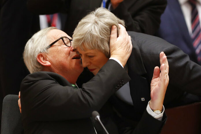 European Commission President Jean-Claude Juncker, left, greets British Prime Minister Theresa May during a round table meeting in December at an EU summit in Brussels, Belgium. Photo: Alastair Grant / Associated Press European Commission President Jean-Claude Juncker, left, greets British Prime Minister Theresa May during a round table meeting in December at an EU summit in Brussels, Belgium. Photo: Alastair Grant / Associated Press