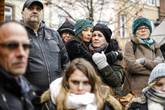 Residents react Sunday during a gathering being held in a central square of the eastern French city of Strasbourg. Photo: Jean-Francois Badias / Associated Press Residents react Sunday during a gathering being held in a central square of the eastern French city of Strasbourg. Photo: Jean-Francois Badias / Associated Press