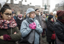 French City Honors Victims of Christmas Market Attack Residents react Sunday during a gathering in a central square of the eastern French city of Strasbourg. Photo: Jean-Francois Badias / Associated Press