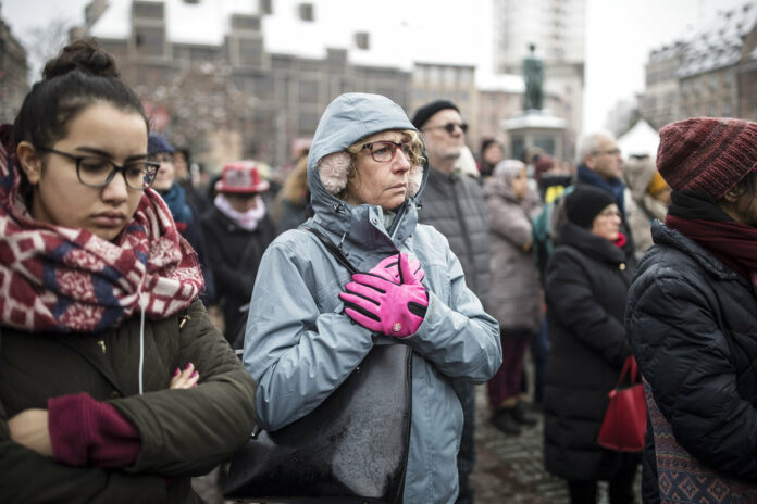 Residents react Sunday during a gathering in a central square of the eastern French city of Strasbourg. Photo: Jean-Francois Badias / Associated Press