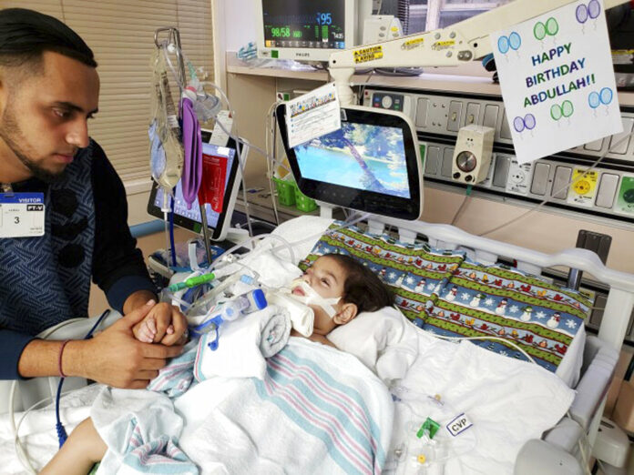 This recent but undated photo, released Monday, shows Ali Hassan with his dying 2-year-old son Abdullah in a Sacramento, California hospital. Photo: Associated Press This recent but undated photo, released Monday, shows Ali Hassan with his dying 2-year-old son Abdullah in a Sacramento, California hospital. Photo: Associated Press
