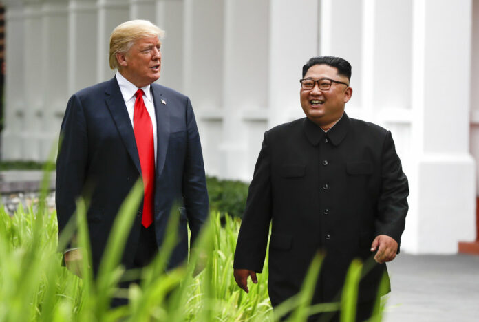 U.S. President Donald Trump, left, and North Korea leader Kim Jong Un walk from their lunch at the Capella resort on Sentosa Island in Singapore on June 12, 2018. (AP Photo/Evan Vucci)