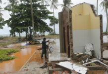 Indonesia Widens Exclusion Zone Around Island Volcano A resident looks for a usable item Monday following a tsunami at a cottage in Tanjung Lesung, Indonesia. Photo: Tatan Syuflana / Associated Press