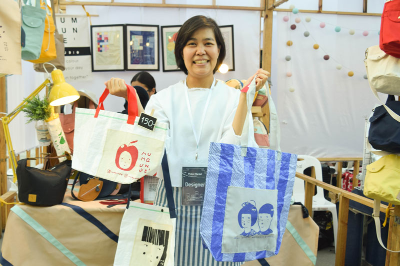 Katchaporn Seetho holds up bags from her Thai brand Numgunde.
