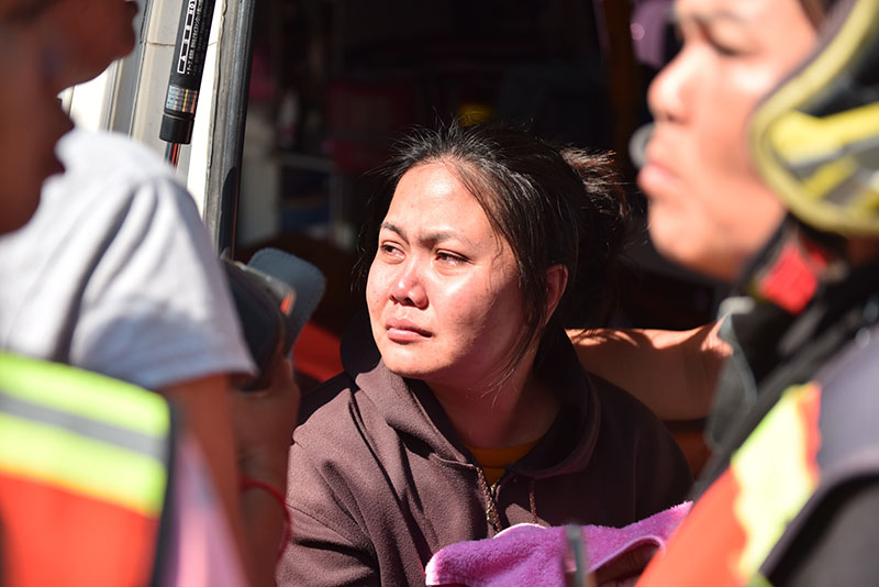 Thida Suracha cries at the scene of her husband's death.