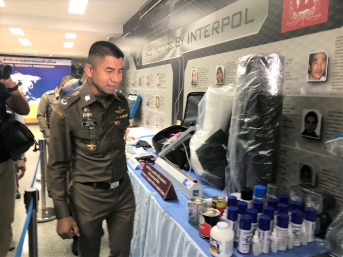 Maj. Gen. Surachate Hakparn, immigration chief, on Monday shows evidence seized from an Iranian man accused of tricking Japanese tourists to smuggle drugs during a press briefing in Bangkok.