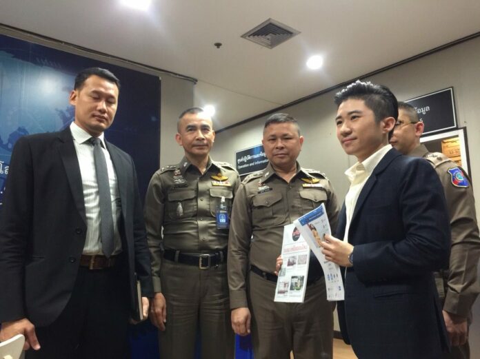 Kitjanut Chaiyosburana, right, meets with police on Wednesday moments before his arrest.