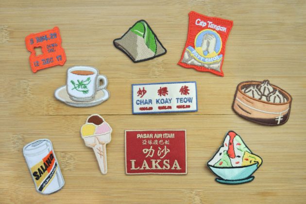 Salang Design patches of Malaysian food items include a bread bag fastener, kopi, nasi lemak, a peanut brand, char koay teow, xiao long bao, Anglia beer, ice cream, laksa and ice kacang.