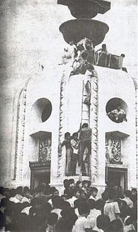The first fatality of the October 14 incident being winched atop the Democracy Monument