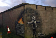 Banksy’s New Work in Wales: A Comment on Air Pollution? A mural by street artist and social commentator Banksy seen Wednesday on a garage in Port Talbot, Wales. Photo: @RHoneyJones /Twitter