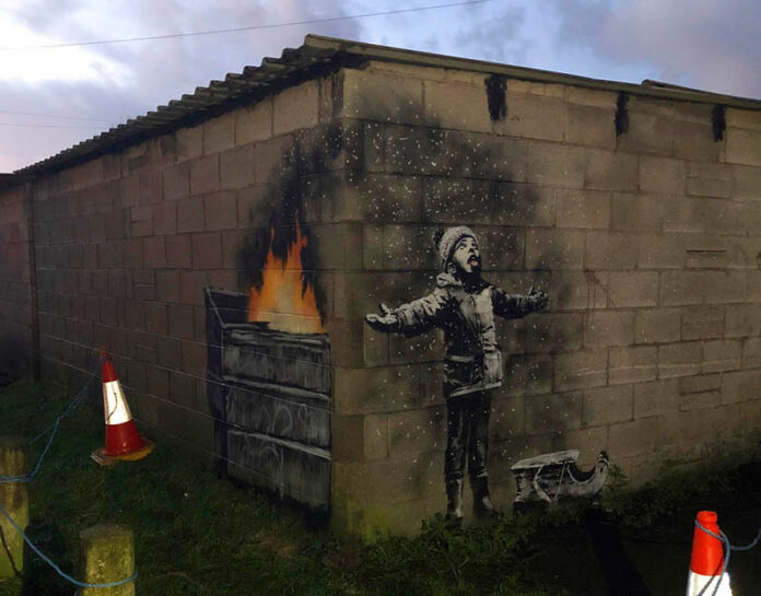 A mural by street artist and social commentator Banksy seen Wednesday on a garage in Port Talbot, Wales. Photo: @RHoneyJones /Twitter