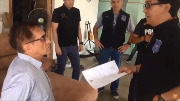 Police question David Kulik about a suspected cannabis export operation as they take him into custody Monday. Image: Matichon Police question David Kulik about a suspected cannabis export operation as they take him into custody Monday. Image: Matichon