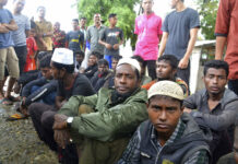 Indonesia Rescues 20 Muslim Rohingya Adrift Off Aceh Rohingya men who were rescued by local fishermen sit on the ground Tuesday in Kuala Idi, Aceh province. Photo: Iskandar Ishak / Associated Press
