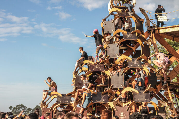 Crowds perch on the Solar Stage at Wonderfruit Festival 2018.