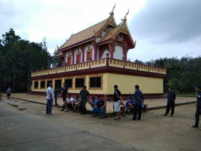 Authorities seen Saturday morning at the Rattana Nuphap Temple, hours after an attack that killed at least two monks.
