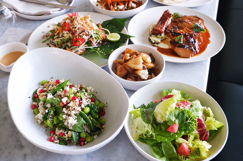 Vietnamese Slaw (390 baht), Crushed potatoes (150 baht), Organic Pork Chop (590 baht), Grains Bowl (320 baht) and Leaves and Herbs Salad (130 baht). 