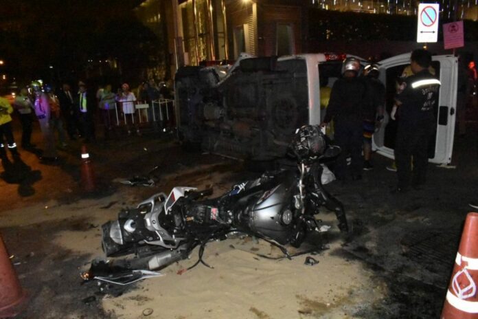 Rescue workers at the scene of a car crash Monday night in Bangkok that killed two Hungarian men.