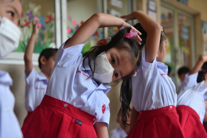 Students wear masks at at Patai Udom Suksa School on Jan. 15 in Bangkok.