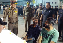 Arrests of Visa Scofflaws Good for Tourism: Big Joke Two foreigners react as Lt. Gen. Surachate Hakparn looks on Friday morning at Bangkok’s Montien Riverside Hotel.