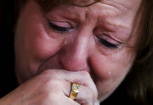 Moms of the Dead From Drugs: ‘Where is the Outrage for Us?’ Terri Osborne, a police dispatcher in Hudson, Mass., cries as she talks about the loss of her son, to an opioid overdose in July 2018, during a group support meeting during her lunch break in Hudson, Massachusetts. Photo: Charles Krupa / Associated Press