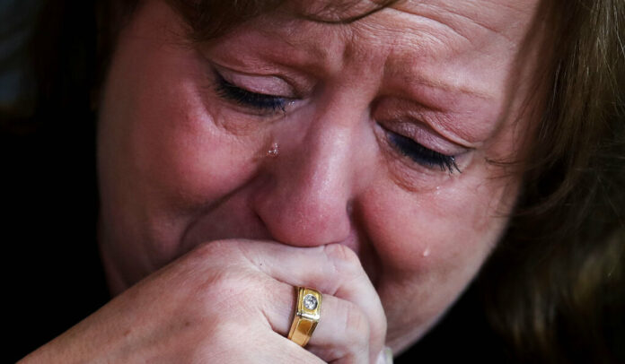 Terri Osborne, a police dispatcher in Hudson, Mass., cries as she talks about the loss of her son, to an opioid overdose in July 2018, during a group support meeting during her lunch break in Hudson, Massachusetts. Photo: Charles Krupa / Associated Press