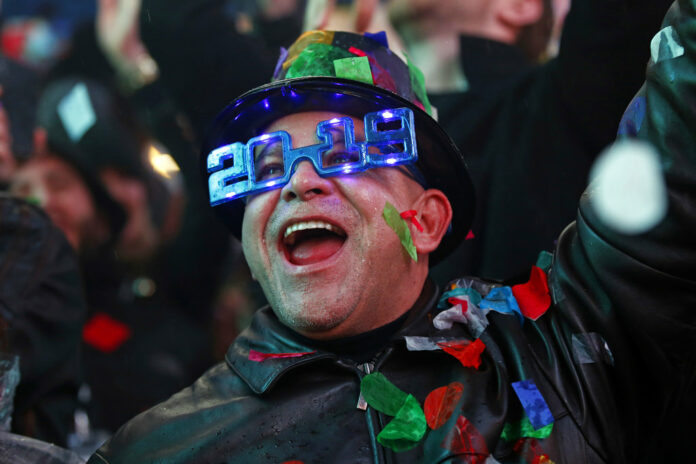 A reveler on Tuesday celebrates as confetti falls during a New Year's celebration in New York's Times Square. Photo: Adam Hunger / Associated Press