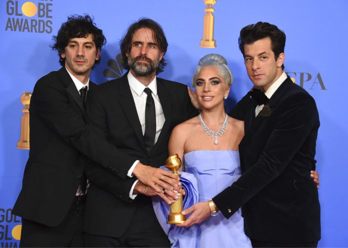 Anthony Rossomando, from left, Andrew Wyatt, Lady Gaga and Mark Ronson pose in the press room with the award for best original song, motion picture for